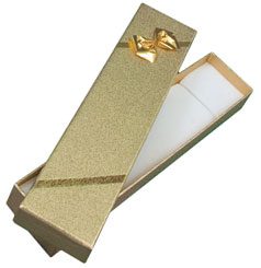 A gold box with a bow on top of it