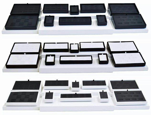 A series of three trays with different sized compartments.