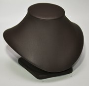 A brown leather necklace holder on top of a table.