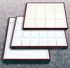 Three trays with white and red edges on a table.