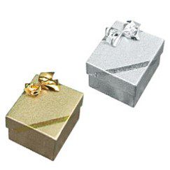 A gold and silver gift box with bow on top.