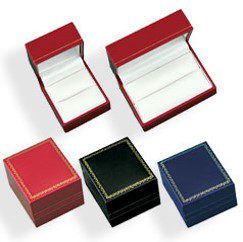 A set of five different colored boxes with rings.