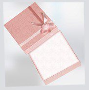 A pink box with a bow on top of it.