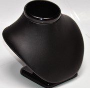 A black necklace holder sitting on top of a table.