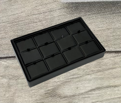 A black tray with 1 2 compartments on top of it.