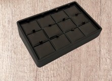 A black tray with ten squares of chocolate.