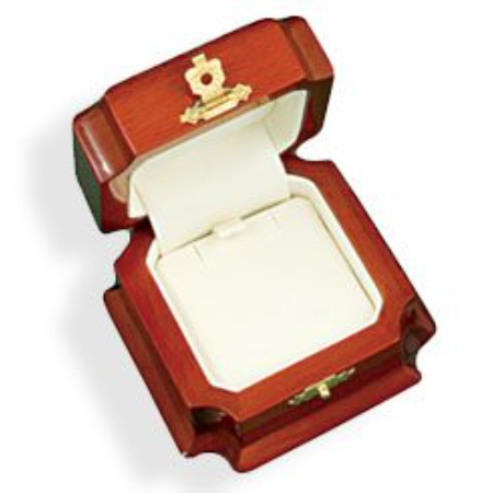 A wooden box with a gold plated ring inside of it