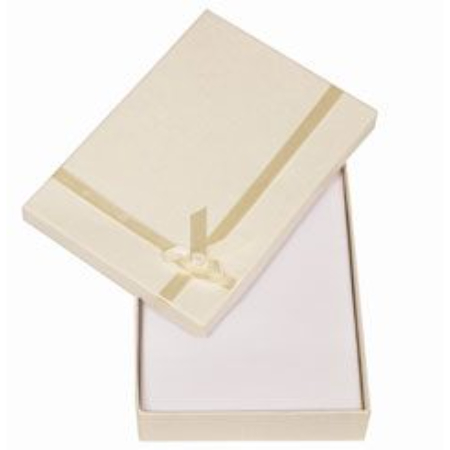 A white box with gold ribbon on top of it.