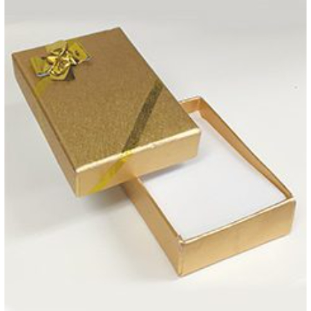 A gold box with a bow on top of it.