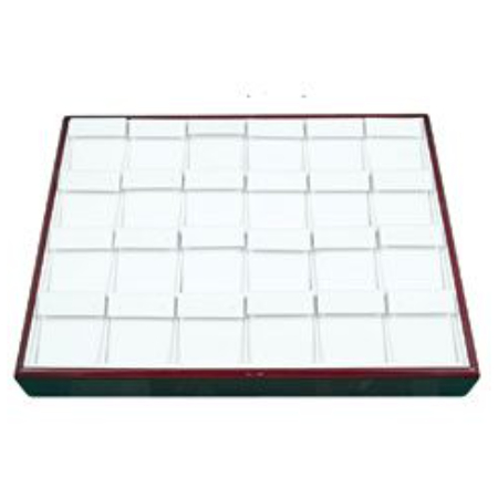 A square tray with many white squares on top.