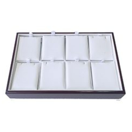 A tray with eight compartments for jewelry.