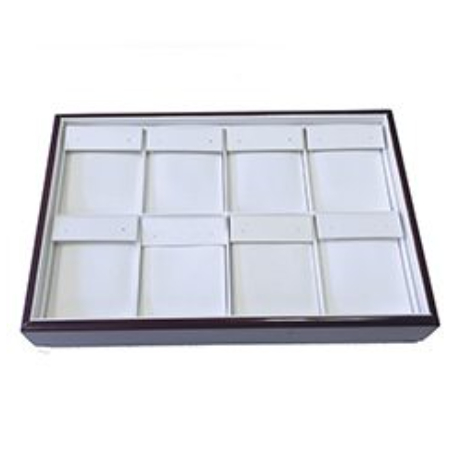 A tray with twelve compartments for jewelry.