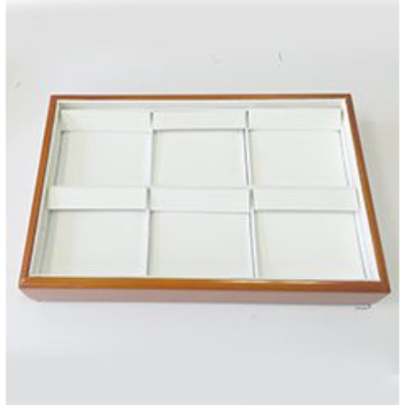 A wooden tray with nine compartments in it.