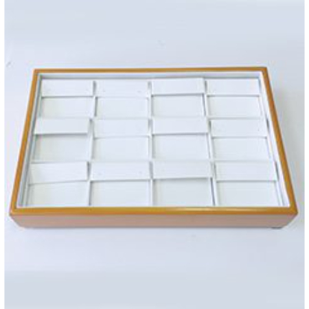 A wooden tray with white dividers in it.