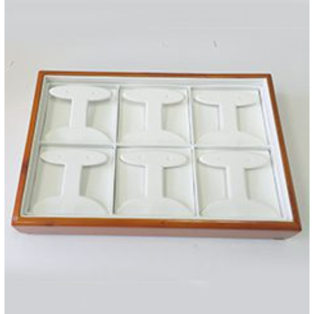 A wooden tray with eight white trays in it.