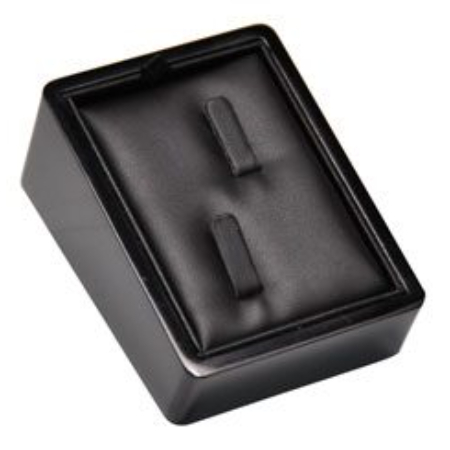 A black box with two pieces of leather on top.