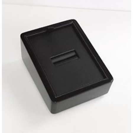 A black box with a slot for coins