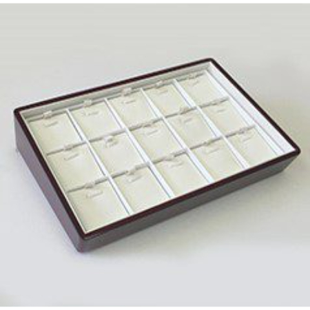 A brown tray with white dividers on top of it.