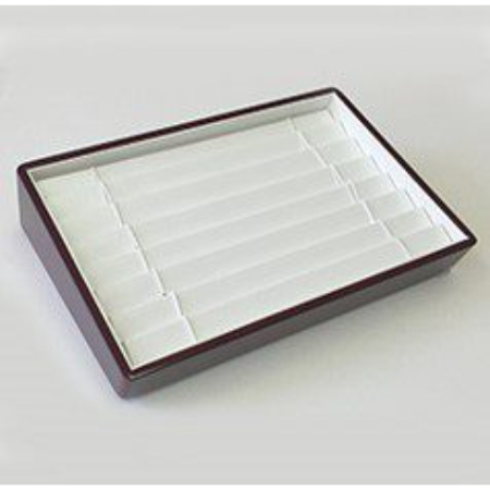 A tray with a white lid and brown frame.