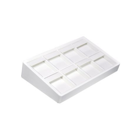 A white tray with eight compartments on top of it.