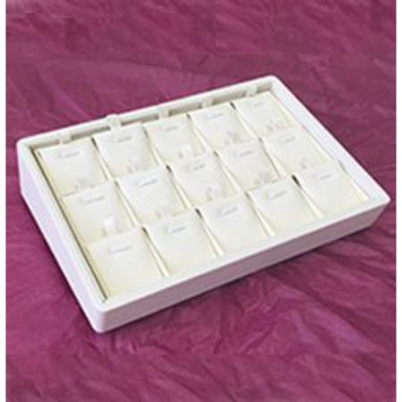 A white tray with many small items in it