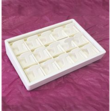 A white tray with 1 6 small squares of soap.