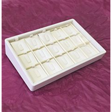 A white tray with many small boxes on top of it.