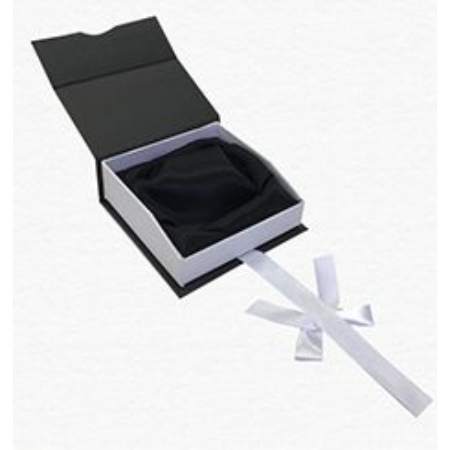 A black box with a white ribbon and a rose in it