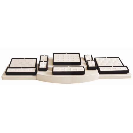 A set of five white and black trays.