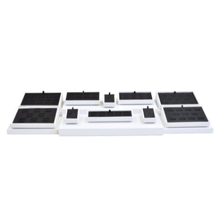 A white tray with black and white trays on top of it.