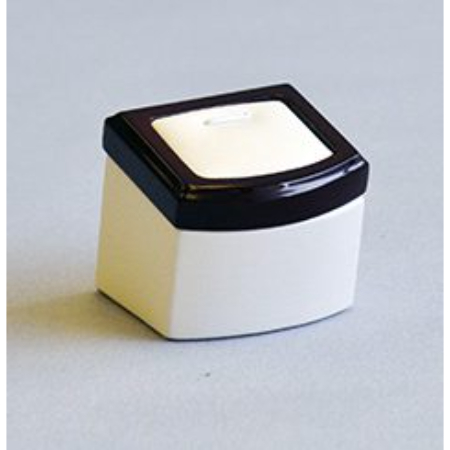 A small white box with black lid on top of the floor.