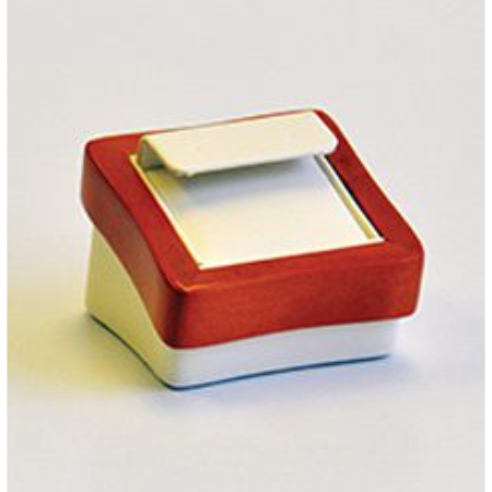 A red and white box with a note pad on top of it.