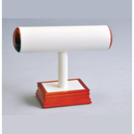 A white and red wooden stand with a roll of wax paper on top.