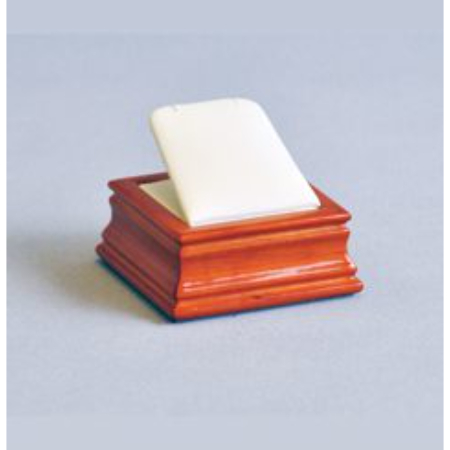 A soap dish with a wooden base and white soap.