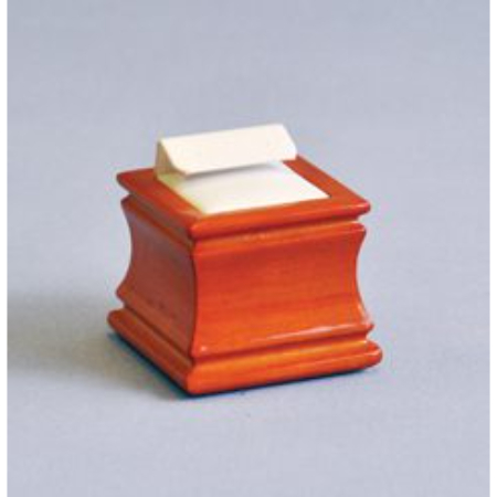 A wooden box with a note on top of it.