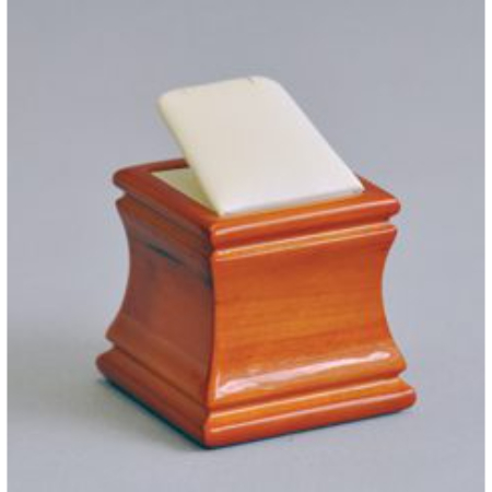 A wooden box with a piece of paper on top.