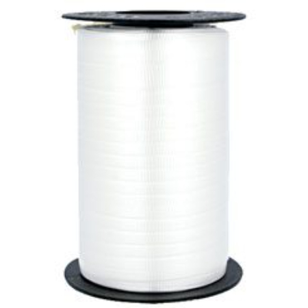 A spool of white ribbon on top of a table.