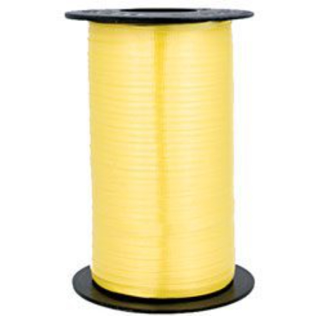 A roll of yellow ribbon on top of a table.