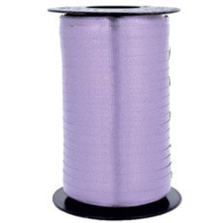 A roll of purple ribbon on top of a table.