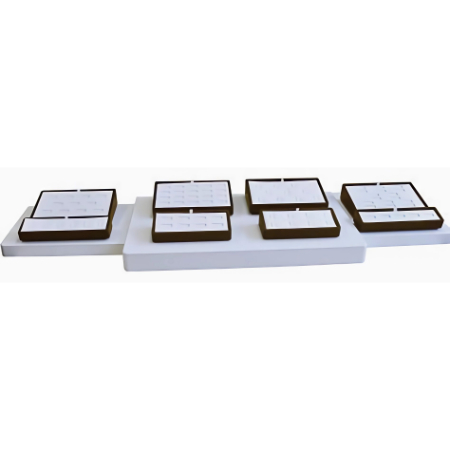 A white tray with four brown trays on top of it.