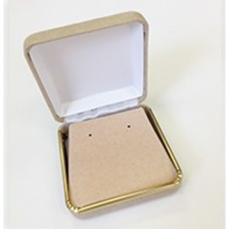 A gold colored box with a white earring holder inside of it.