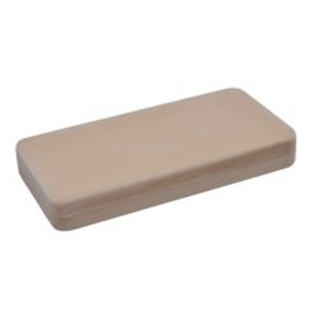 A tan rectangular shaped object sitting on top of a table.