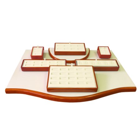 A white tray with brown trim and five small trays.