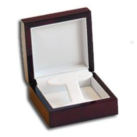 A wooden box with a t-shaped tie clip in it.